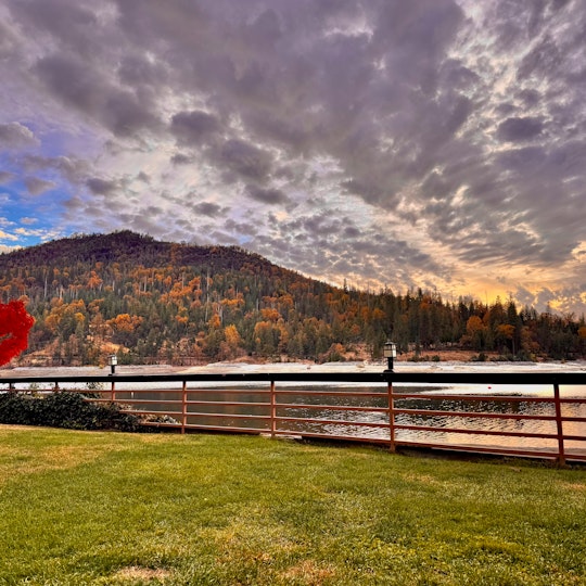 Sunset over Bass Lake in fall with colorful trees and calm water